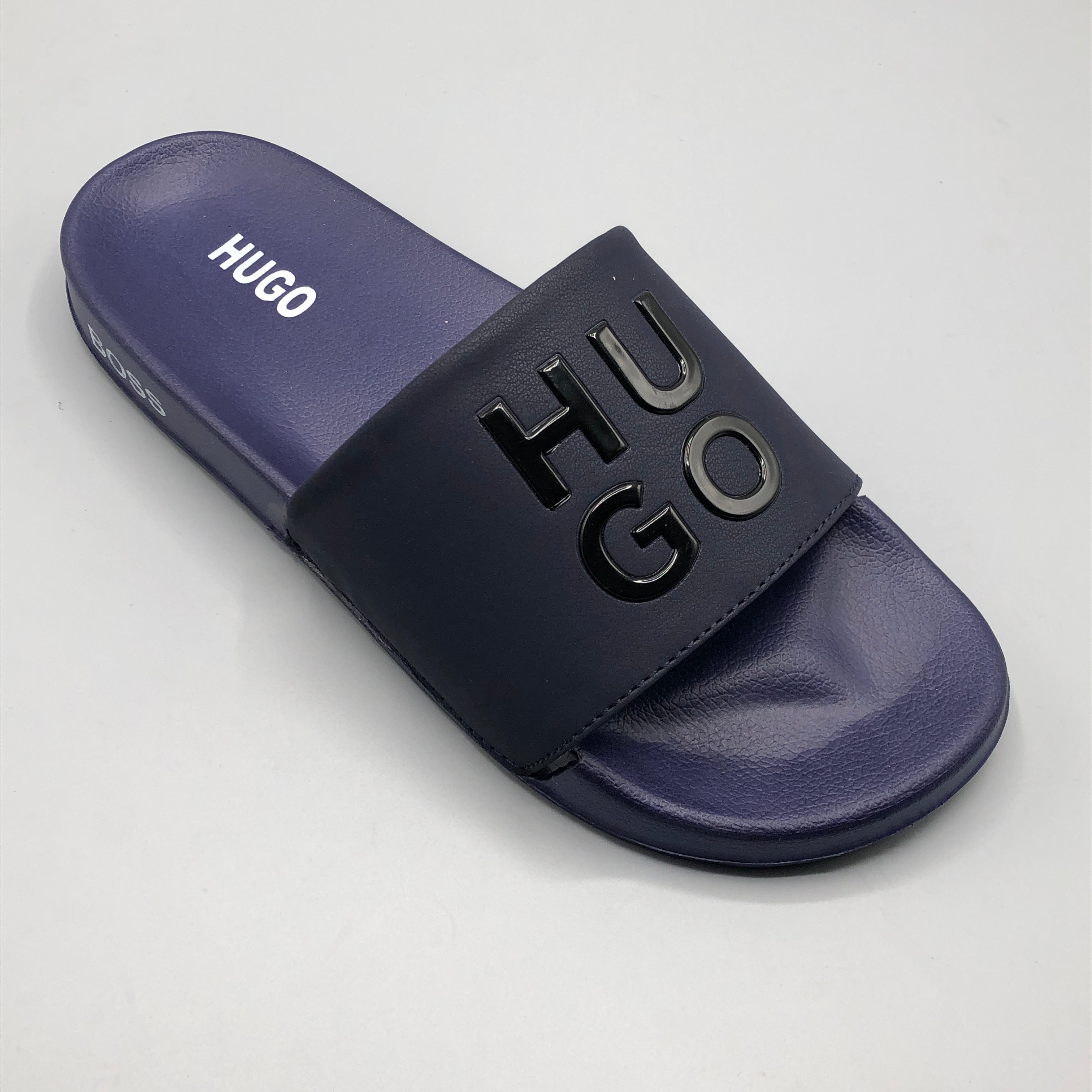 Navy , Close up of premium 3D embossed HUGO logo on navy blue leather strap slipper