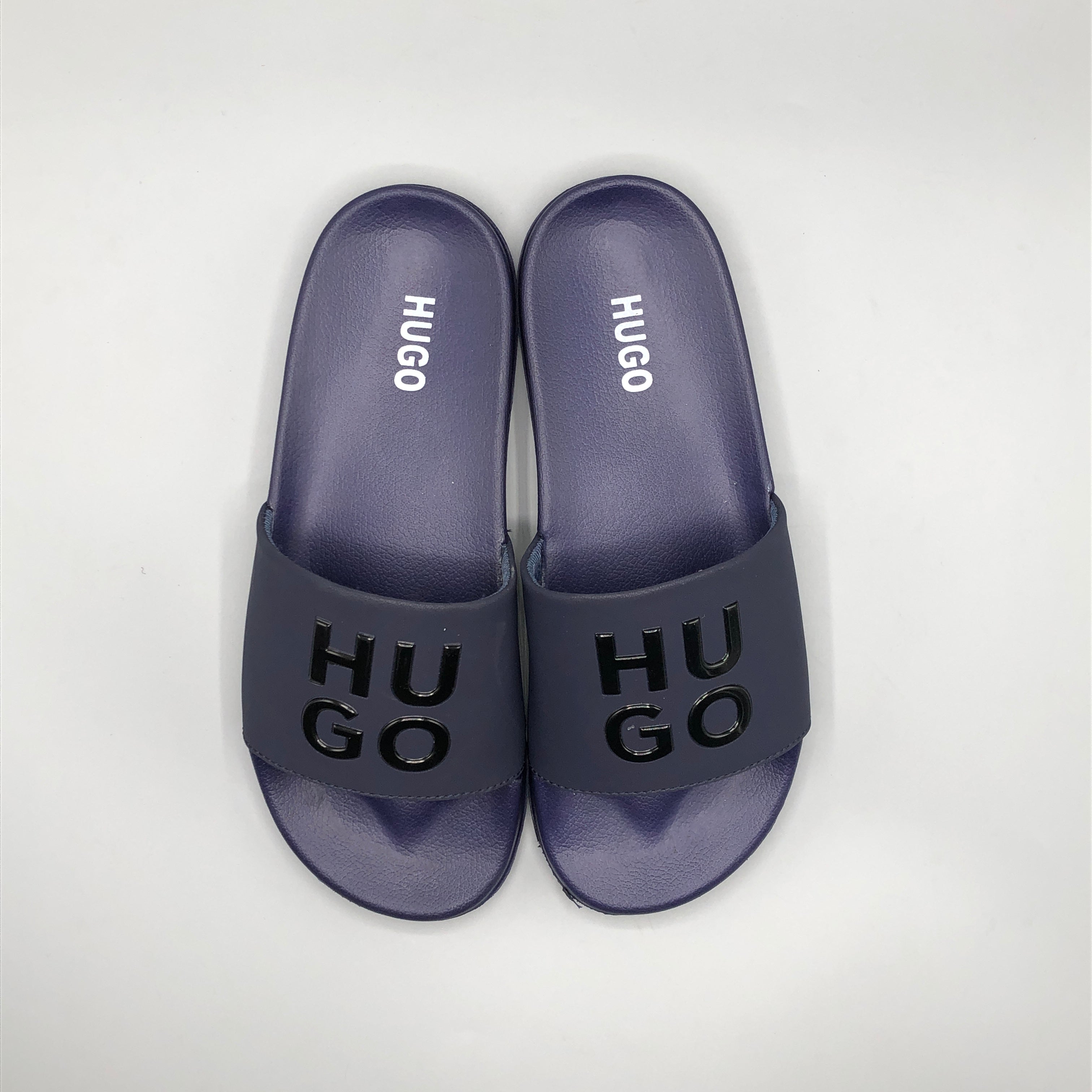 Navy , Model wearing HUGO navy blue casual chappal with denim jeans